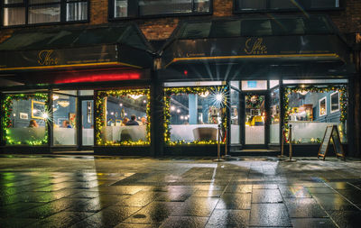 Illuminated building by street at night