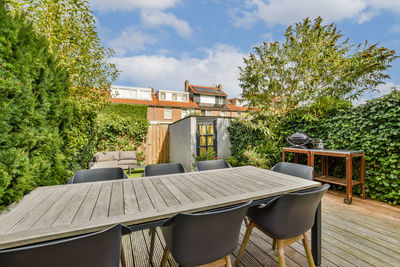 Empty chairs and tables in yard