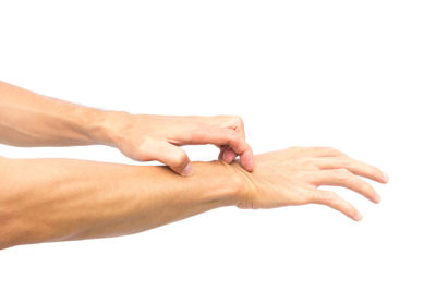 Close-up of hands over white background