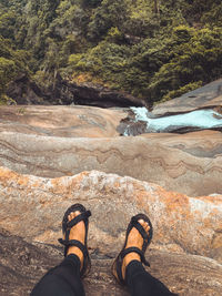 Low section of person standing on rock