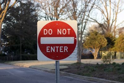 Close-up of road sign against trees