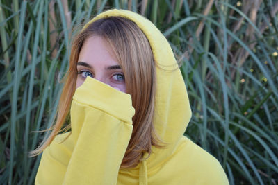 Portrait of beautiful woman with yellow hair against plants