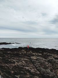 Man looking at sea against sky