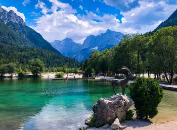 Scenic view of lake and mountains against sky