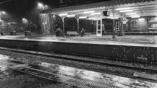 Illuminated railroad station platform at night