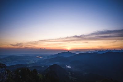 Scenic view of silhouette mountains against sky at sunset