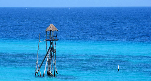 Scenic view of sea against clear blue sky