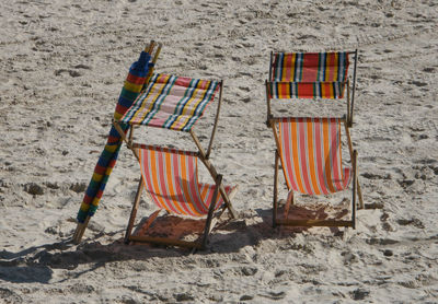 Chairs on sand at beach