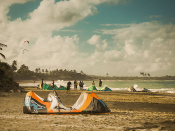 Panoramic view of people on beach against sky