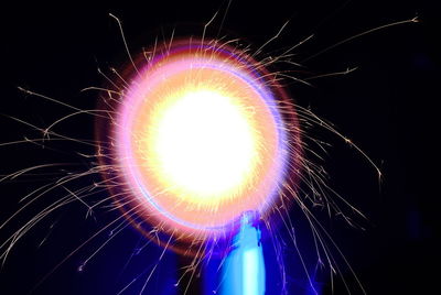 Low angle view of illuminated fireworks against sky at night