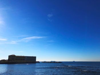 Scenic view of sea against blue sky