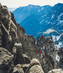 People relaxing on rocky mountains