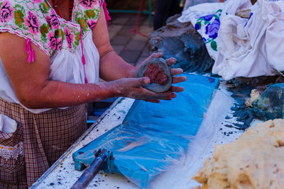 Indigenous mexican woman preparing tortillas by hand