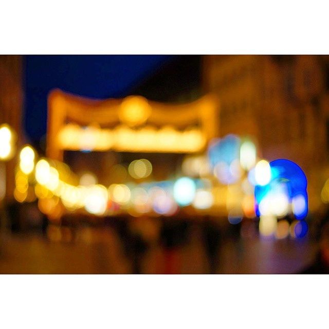 transfer print, illuminated, night, auto post production filter, defocused, multi colored, lighting equipment, light - natural phenomenon, city, selective focus, building exterior, street, focus on foreground, no people, built structure, architecture, indoors, light, blurred motion