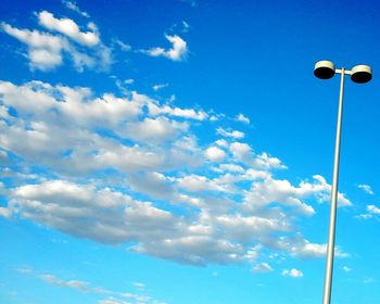 Low angle view of street light against blue sky
