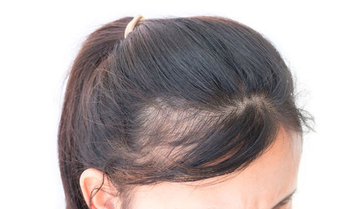 Young woman with hair against white background