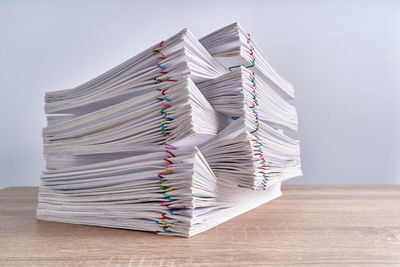 Stack of books on table against white background