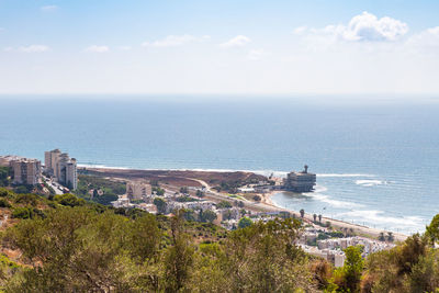 High angle view of buildings and sea against sky