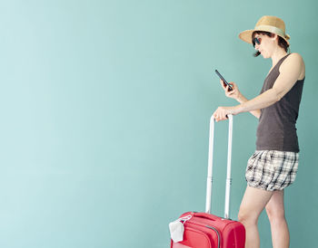 Midsection of woman holding mobile phone