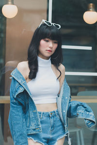 Thoughtful young woman standing in cafe 