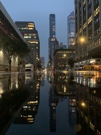 Reflection of illuminated buildings in city at night