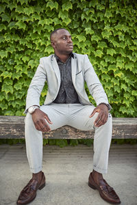 Full length of young man sitting on bench