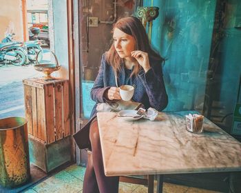 Portrait of a young woman sitting on bench