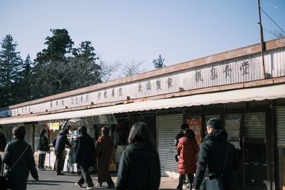 Rear view of people walking in city