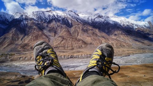 Low section of person on snowcapped mountain