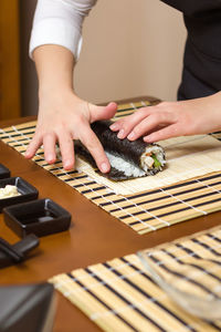 Midsection of woman holding table