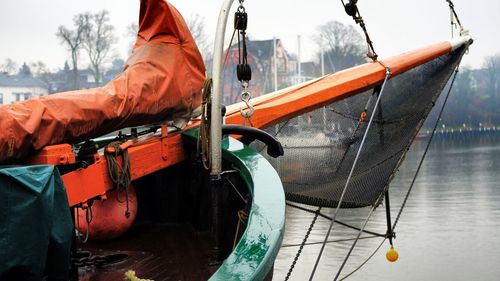 Fishing boat moored in sea during winter