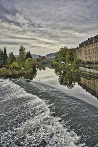 River flowing amidst trees against sky