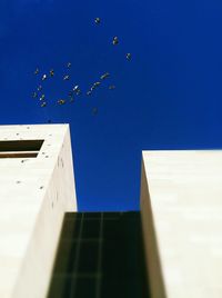 Low angle view of building against clear blue sky