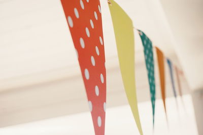 Low angle view of multi colored bunting hanging on wall