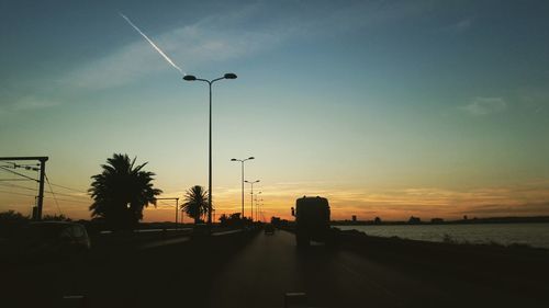 Street against sky at sunset