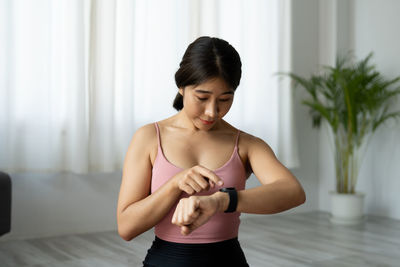 Woman using smart watch at home