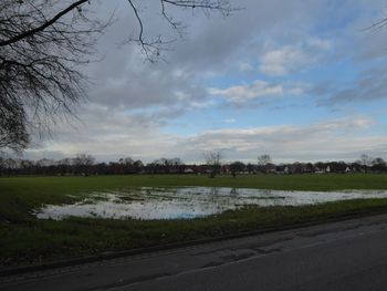 Road by lake against sky