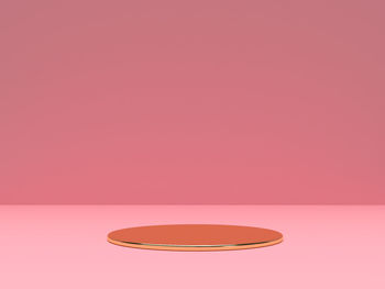 Close-up of light bulb on pink table against wall
