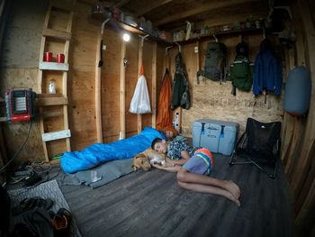 Siblings relaxing in shed