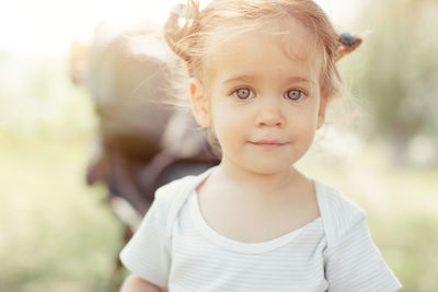 Portrait of cute girl standing on field