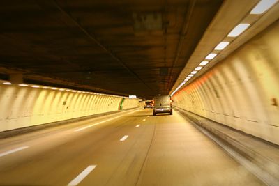 Cars moving on road in tunnel