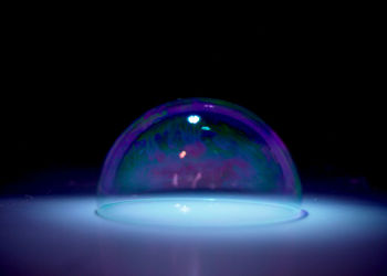 Close-up of crystal ball against black background