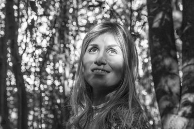 Close-up of woman looking away in forest