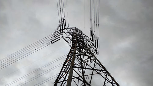 Low angle view of electricity pylon against sky