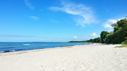 Scenic view of beach against blue sky
