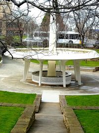 Park bench on footpath by building