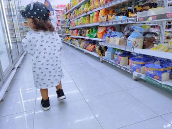 Rear view of girl standing at store