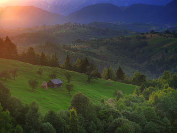 High angle view of trees and mountains against sky during sunset