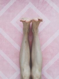 Low section of woman lying on floor