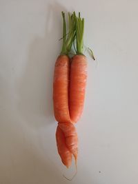 Cropped hand of woman with vegetables on table